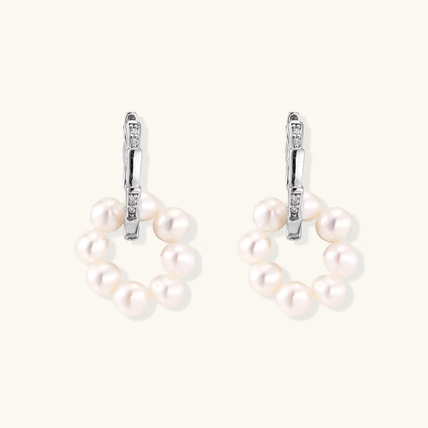 Rhodium-plated silver hoop earrings with freshwater pearls arranged in crescent formation and diamond accents