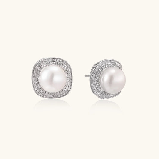 Cushion-shaped sterling silver stud earrings with freshwater pearls surrounded by geometric diamond halos