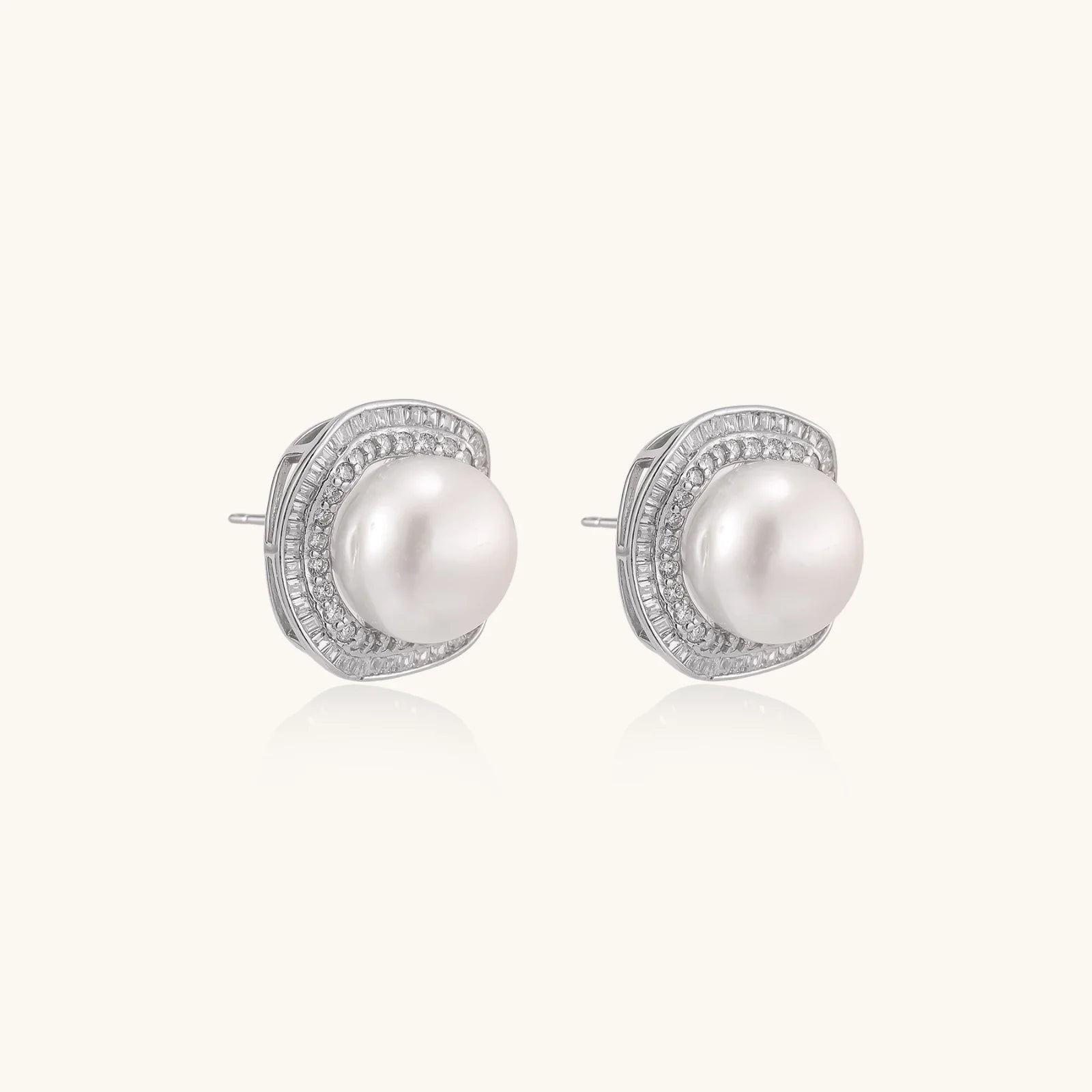 Cushion-shaped sterling silver stud earrings with freshwater pearls surrounded by geometric diamond halos