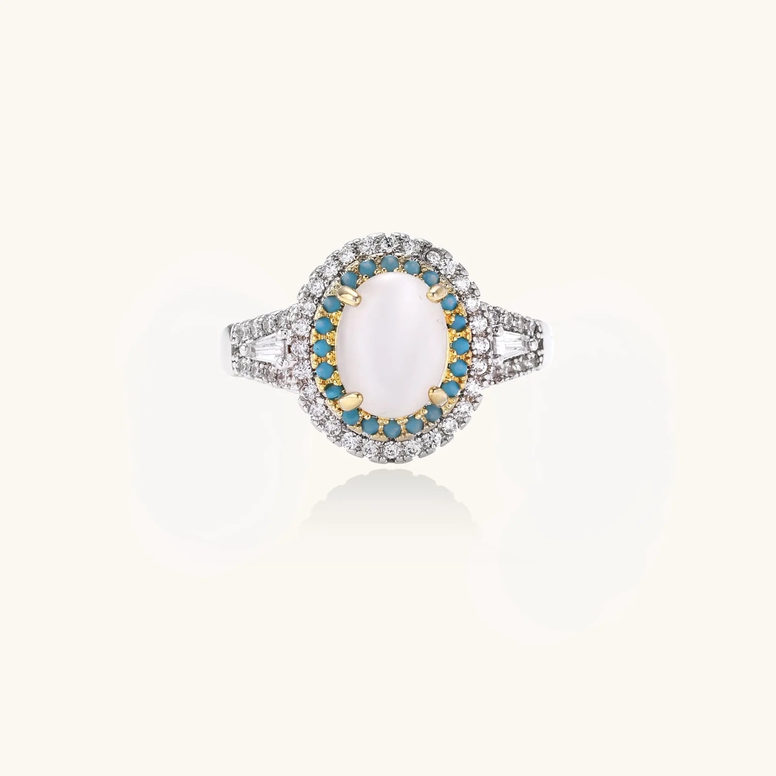 Vintage-style cocktail ring with luminous cat's eye center stone surrounded by turquoise and crystal double halo on white gold plated band