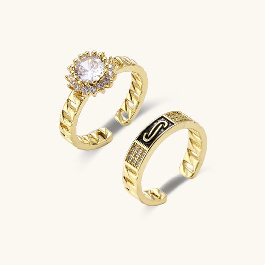 Gold-plated adjustable ring with twisted chain band, central cubic zirconia stone surrounded by crystal halo on cream background